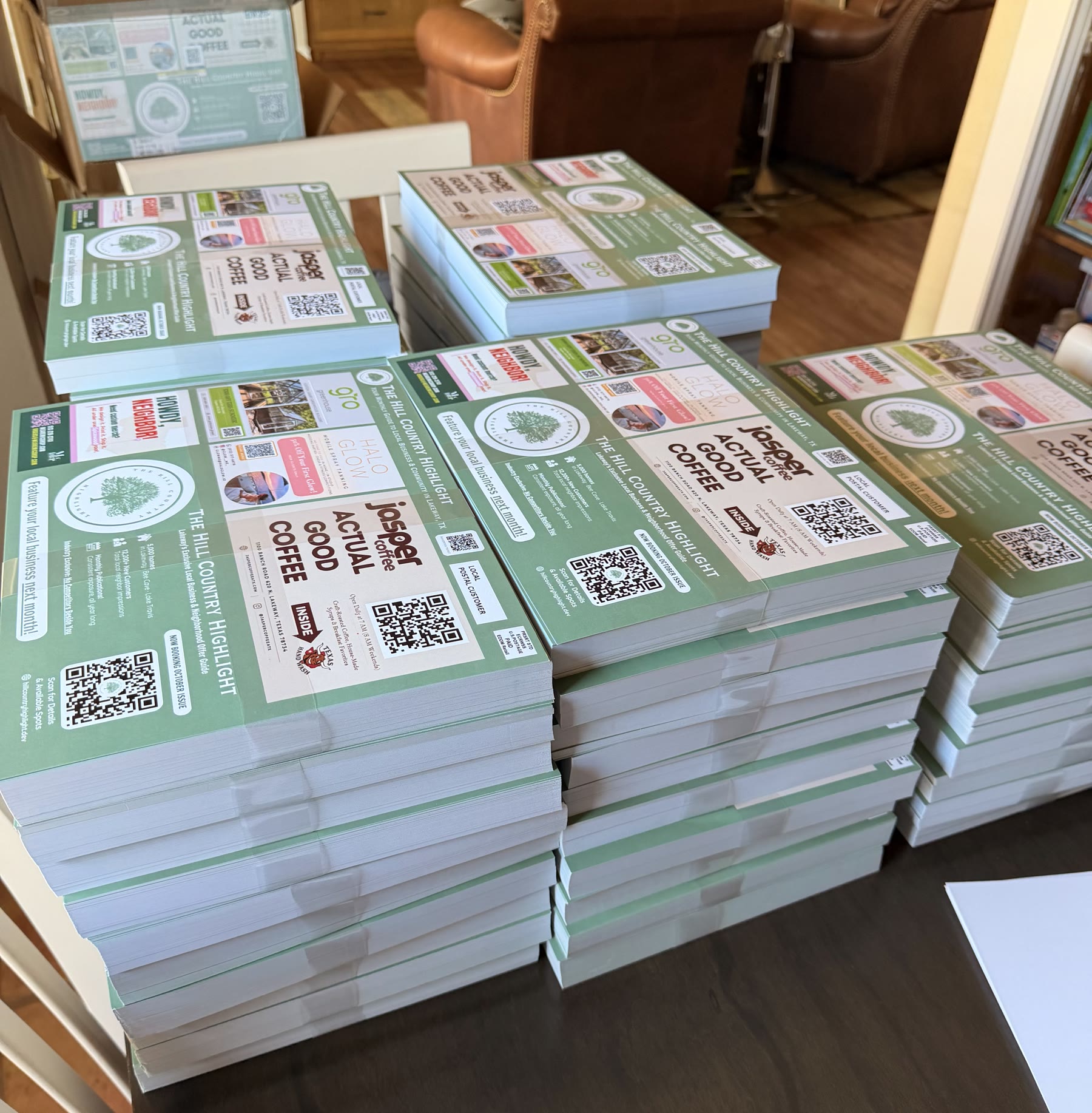 Stacks of printed mailer cards ready for delivery