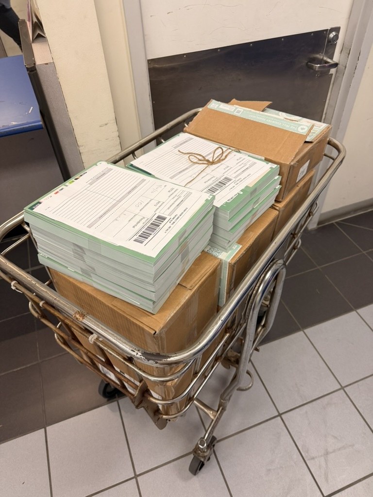 Bundled mailers loaded on a cart at the post office