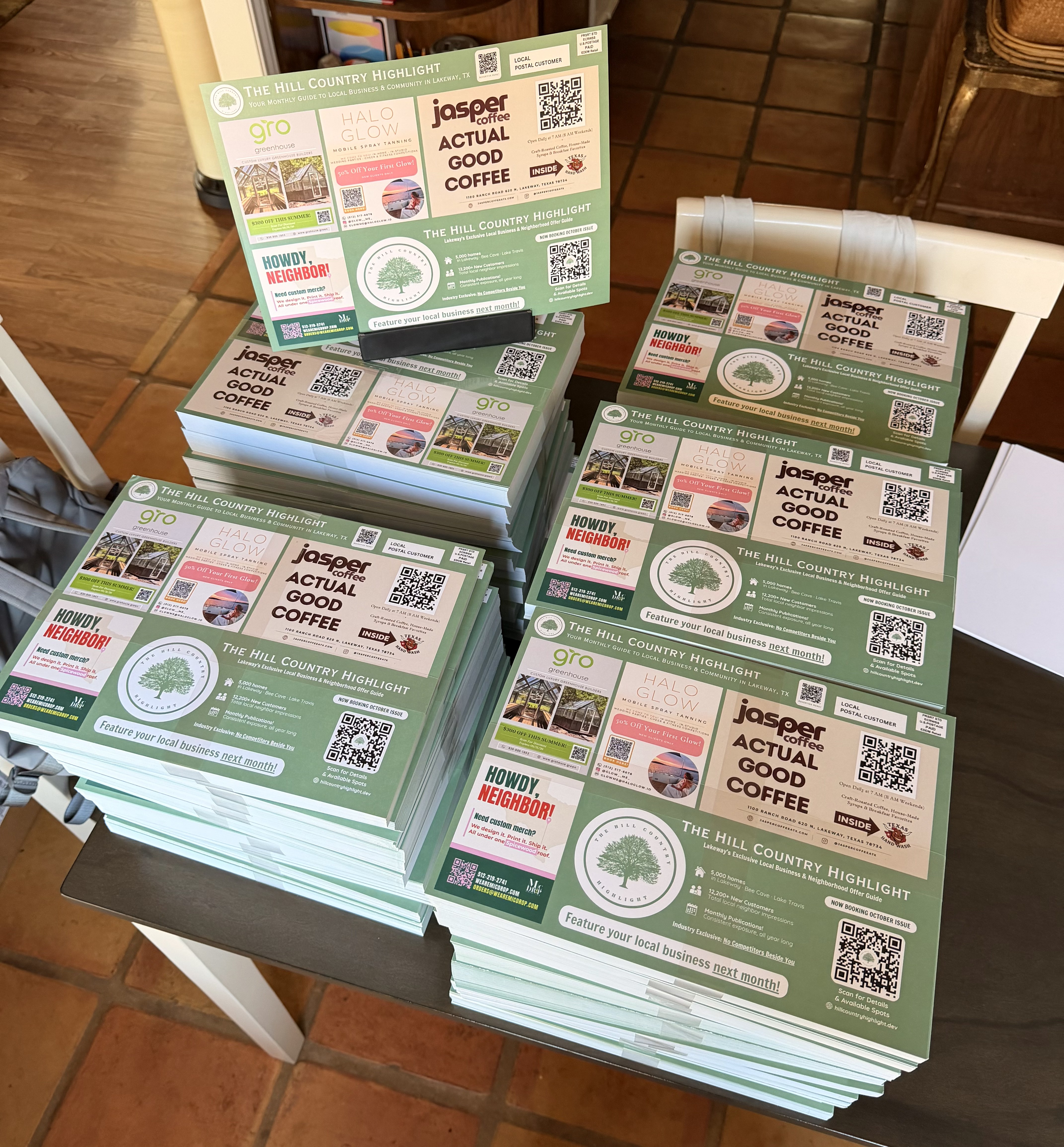 Stacks of printed mailer cards ready for delivery